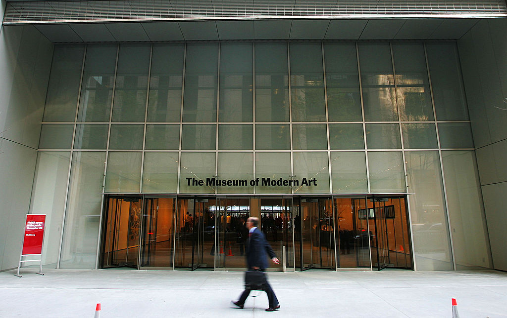 NEW YORK - NOVEMBER 17: A pedestrian walks outside the entrance to the new Museum of Modern Art building on 53rd Street November 17, 2004 in New York City. The new Yoshio Taniguchi-designed building opens to the public November 20. (Photo by Chris Hondros/Getty Images)